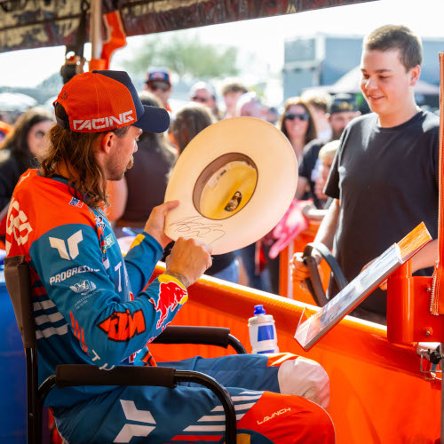 Aaron Plessinger signs a hat for a fan