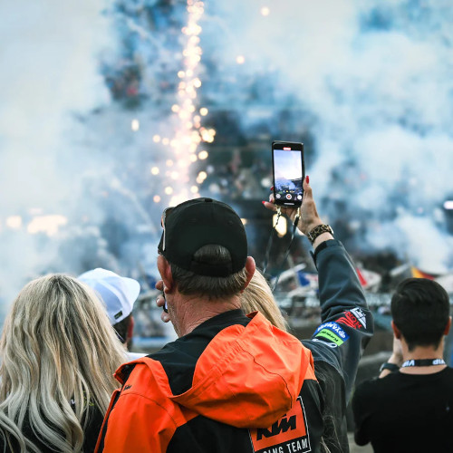 Fans taking photos of fireworks at an SMX event