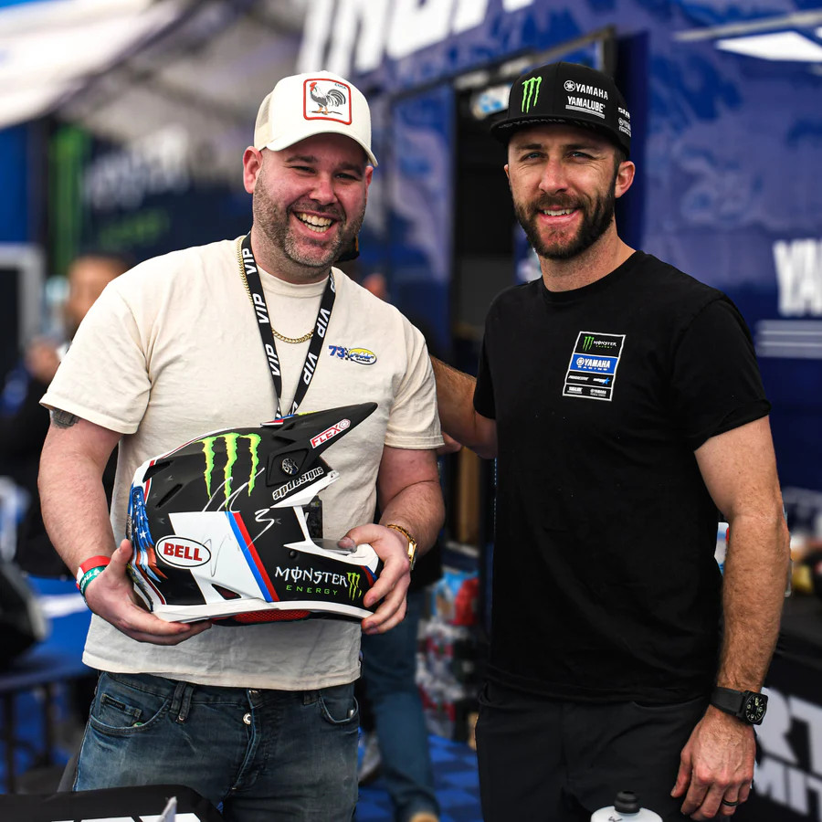 Fan poses for a photo with Eli Tomac
