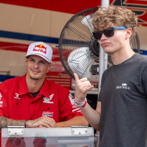 Fan poses for a photo with an SMX rider
