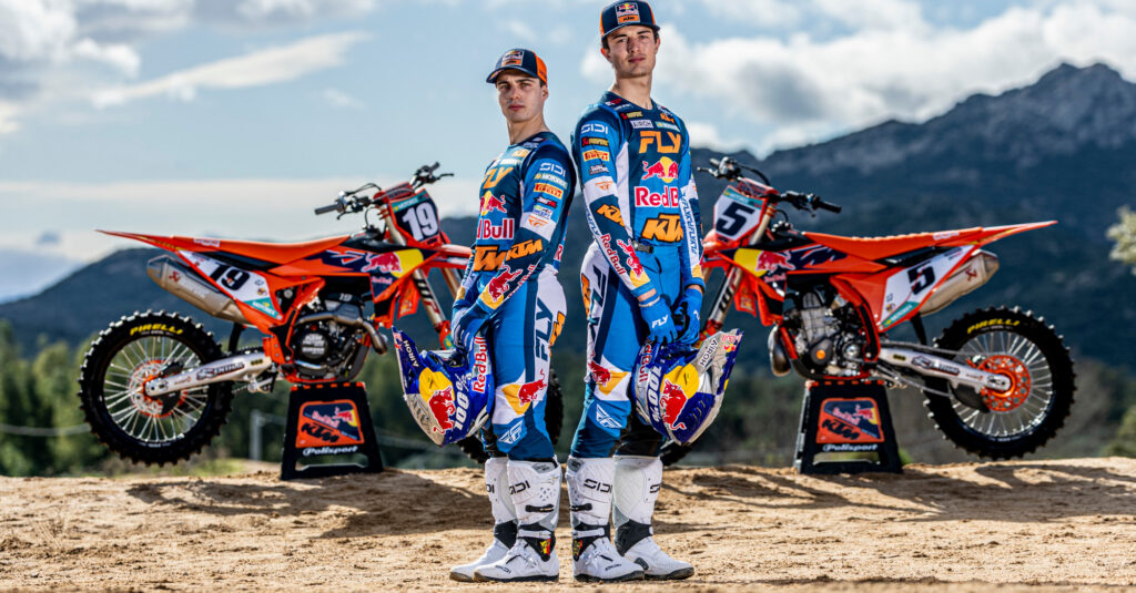 Lucas and Sacha Coenen standing in front of Red Bull KTM Factory Racing bikes. Photo credit Red Bull KTM Factory Racing